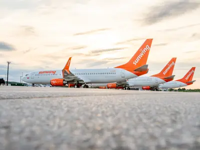 Sunwing airplanes on the runway at YKF